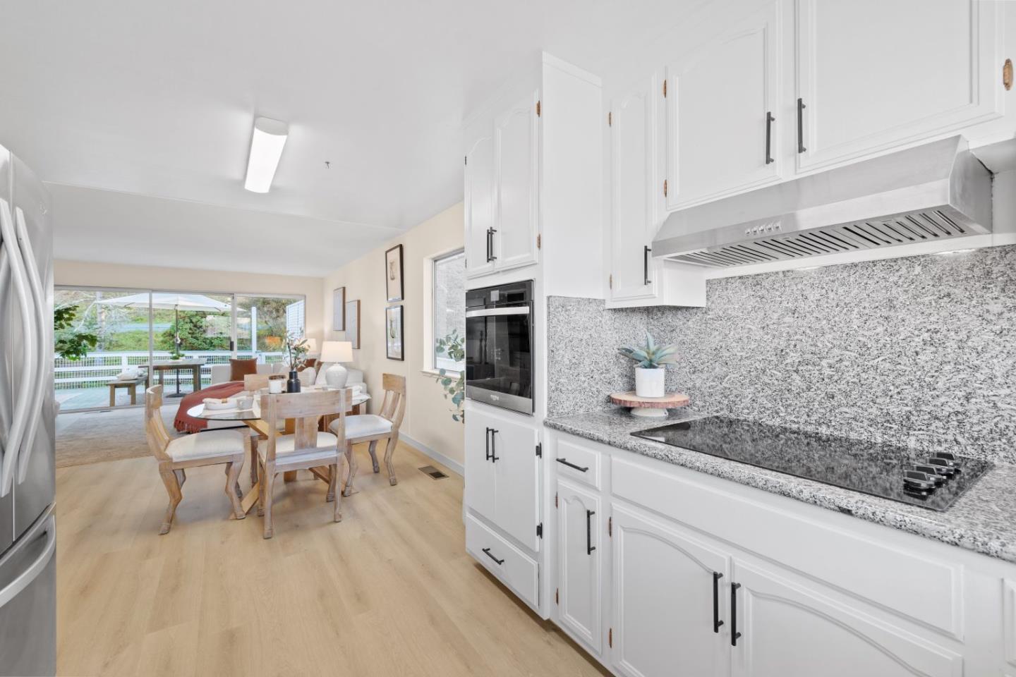 1250 Tuolumne Road Millbrae, CA 94030 - Photo 14 of 56 a kitchen with stainless steel appliances kitchen island granite countertop a sink and cabinets