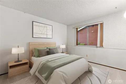 a bedroom with a bed and a night stand
