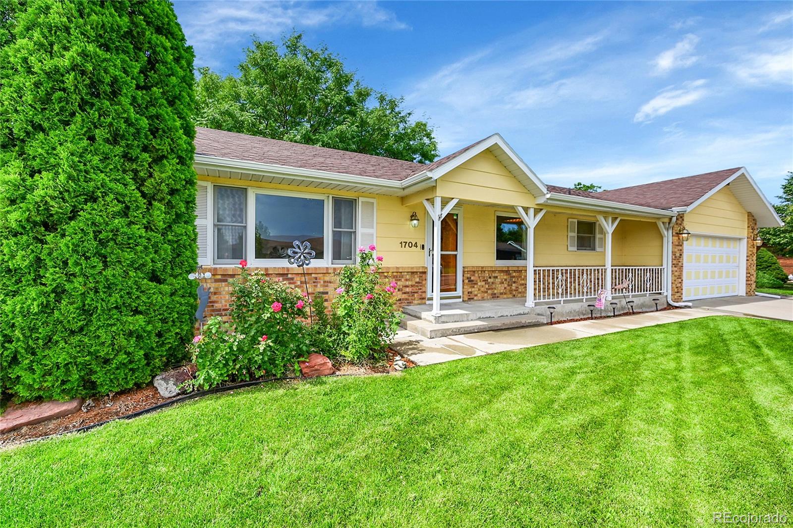 a view of a house with a yard and sitting area