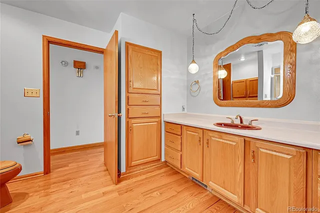 a view of a living room with furniture and wooden floor