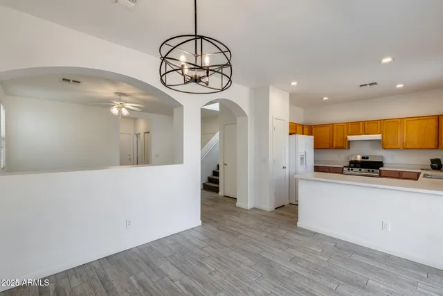 a view of a kitchen with a sink stainless steel appliances and cabinets