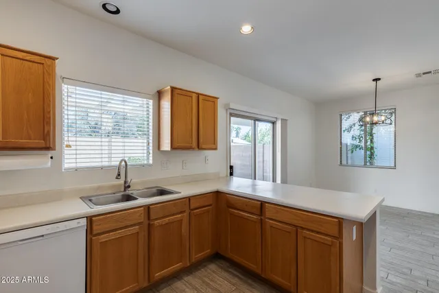 a kitchen with granite countertop a sink cabinets and window