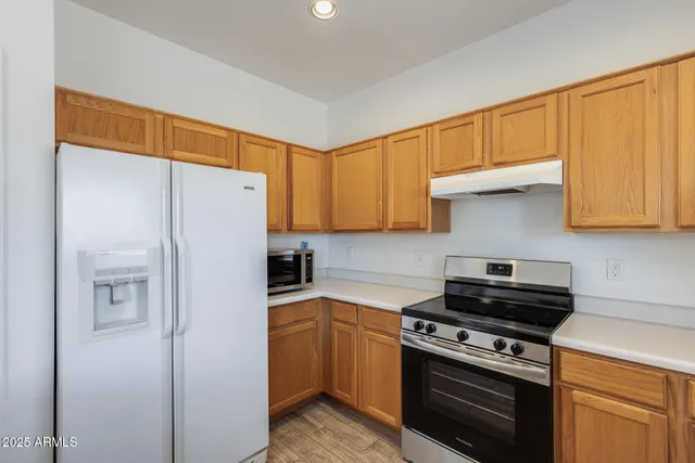 a kitchen with a refrigerator stove and cabinets