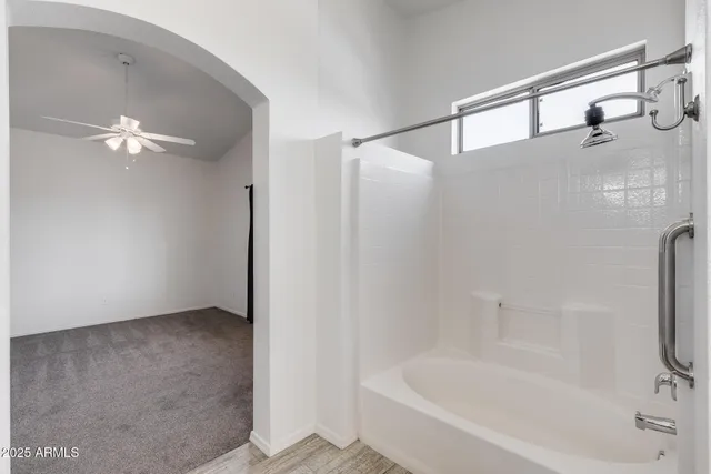 a bathroom with a bathtub and a shower