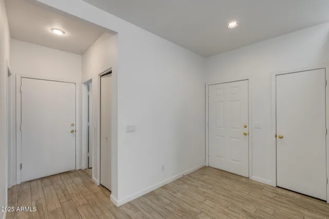 a view of hallway with wooden floor