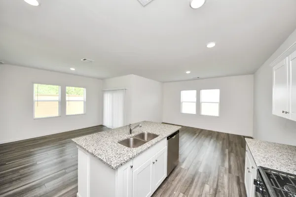 a kitchen with a sink and a stove top oven