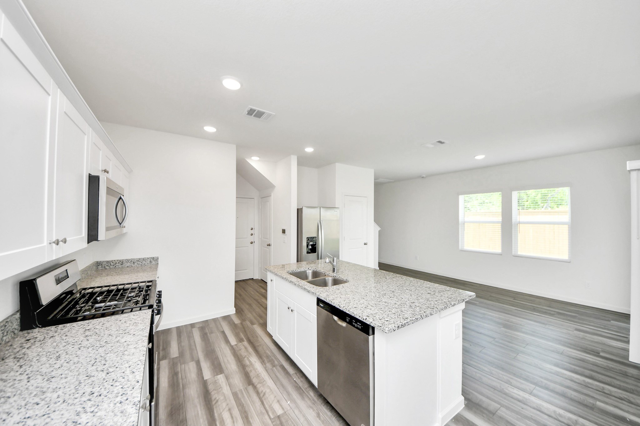 10303 Rose Mar Drive, Unit A Rosharon, TX 77583 - Photo 13 of 49 a kitchen with a sink stove and cabinets