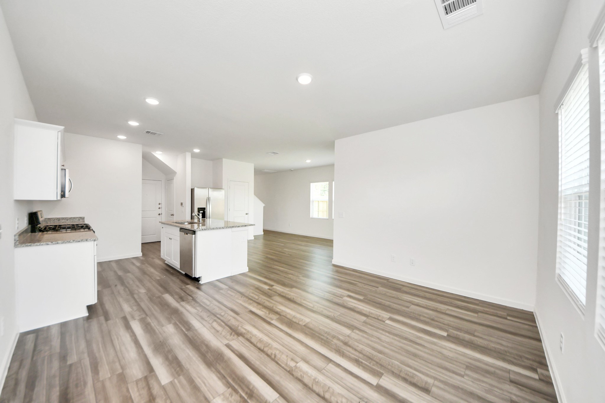 10303 Rose Mar Drive, Unit A Rosharon, TX 77583 - Photo 16 of 49 a view of kitchen with kitchen island wooden floors and stainless steel appliances