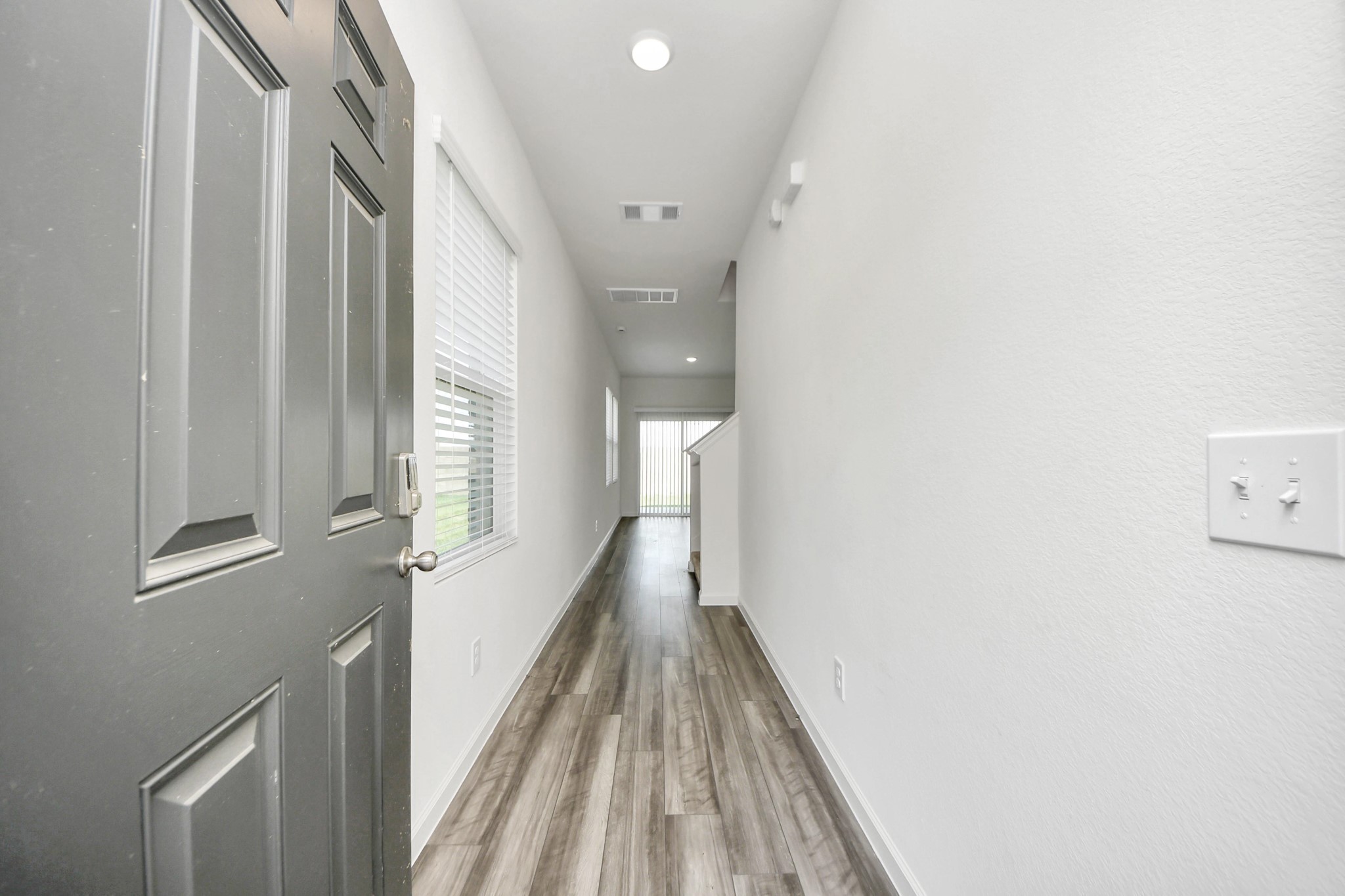 10303 Rose Mar Drive, Unit A Rosharon, TX 77583 - Photo 35 of 49 a view of a hallway with wooden floor and staircase