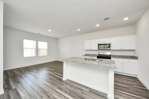 a kitchen with a stove a sink and a refrigerator