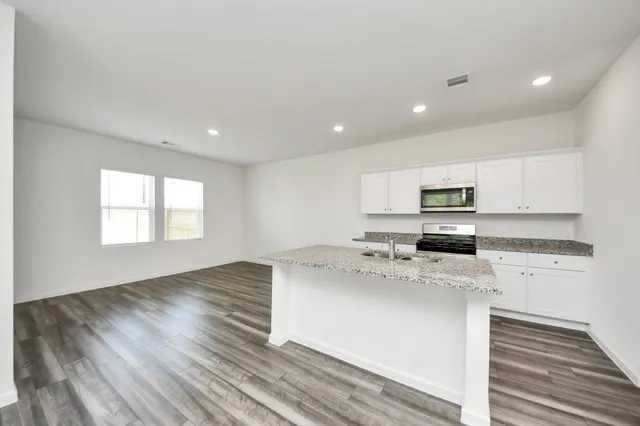 a kitchen with a stove a sink and a refrigerator