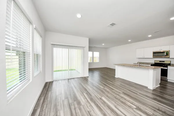 a view of kitchen with wooden floor and electronic appliances