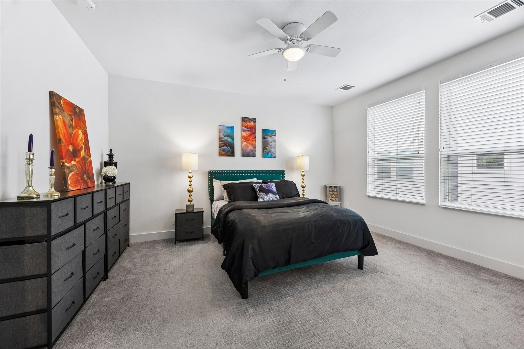 1310 Hussion Street Houston, TX 77003 - Photo 17 of 34 This bedroom is bright and spacious, featuring large windows with blinds, a ceiling fan, and neutral carpeting.