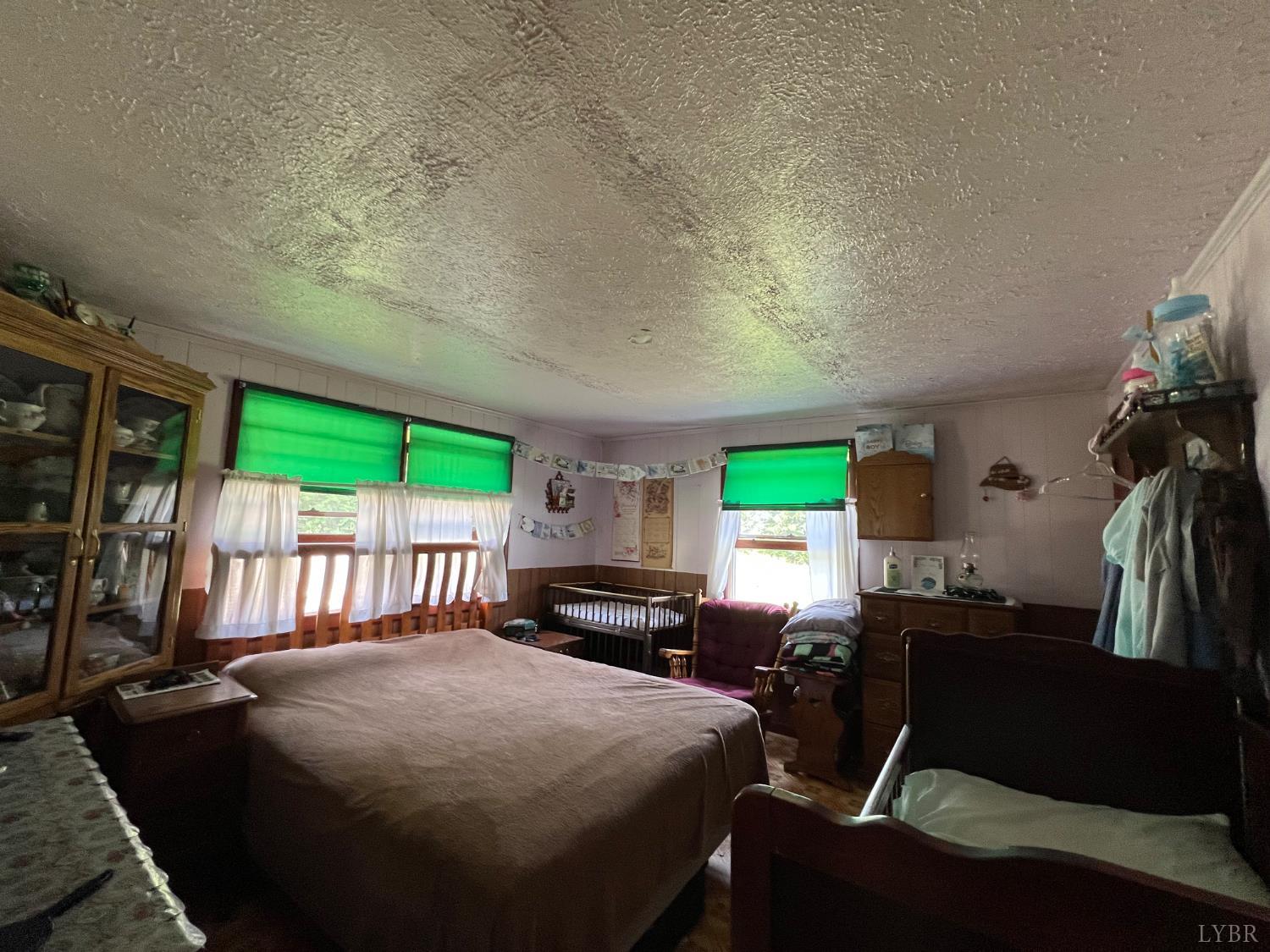 8288 Red House Road Phenix, VA 23959 - Photo 3 of 22 a bedroom with furniture and a large window