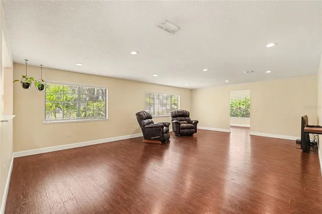 a view of a living room a dining room and wooden floor