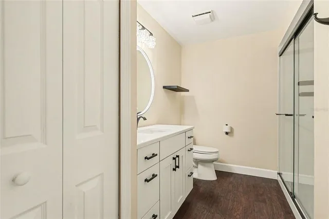 a bathroom with a granite countertop toilet and a shower