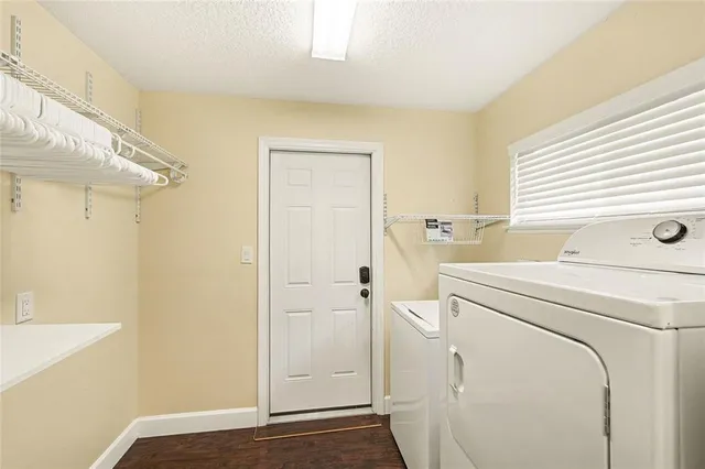 a view of a storage & utility room with dryer and washer