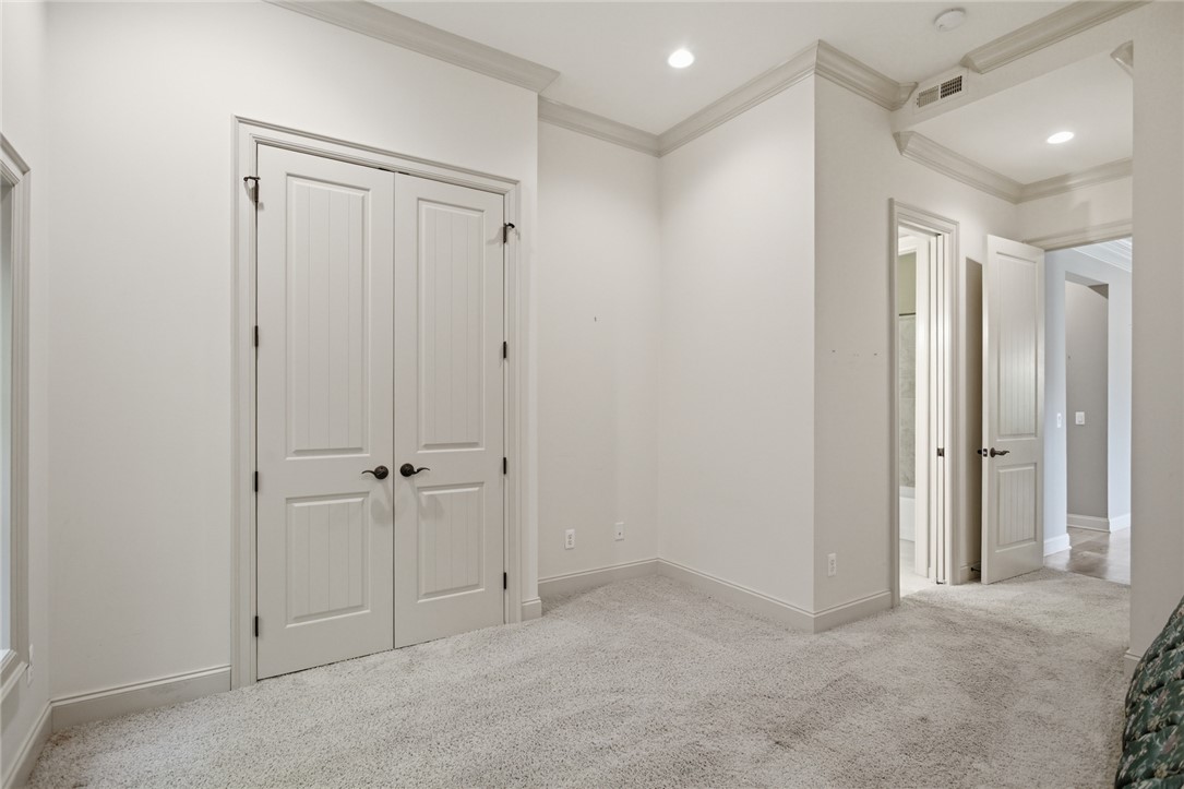 130 River Ridge Road Sunset, SC 29685 - Photo 34 of 47 This plush carpeted room features elegant crown molding and recessed lighting, offering a versatile space.