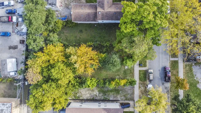 an aerial view of a house with a yard