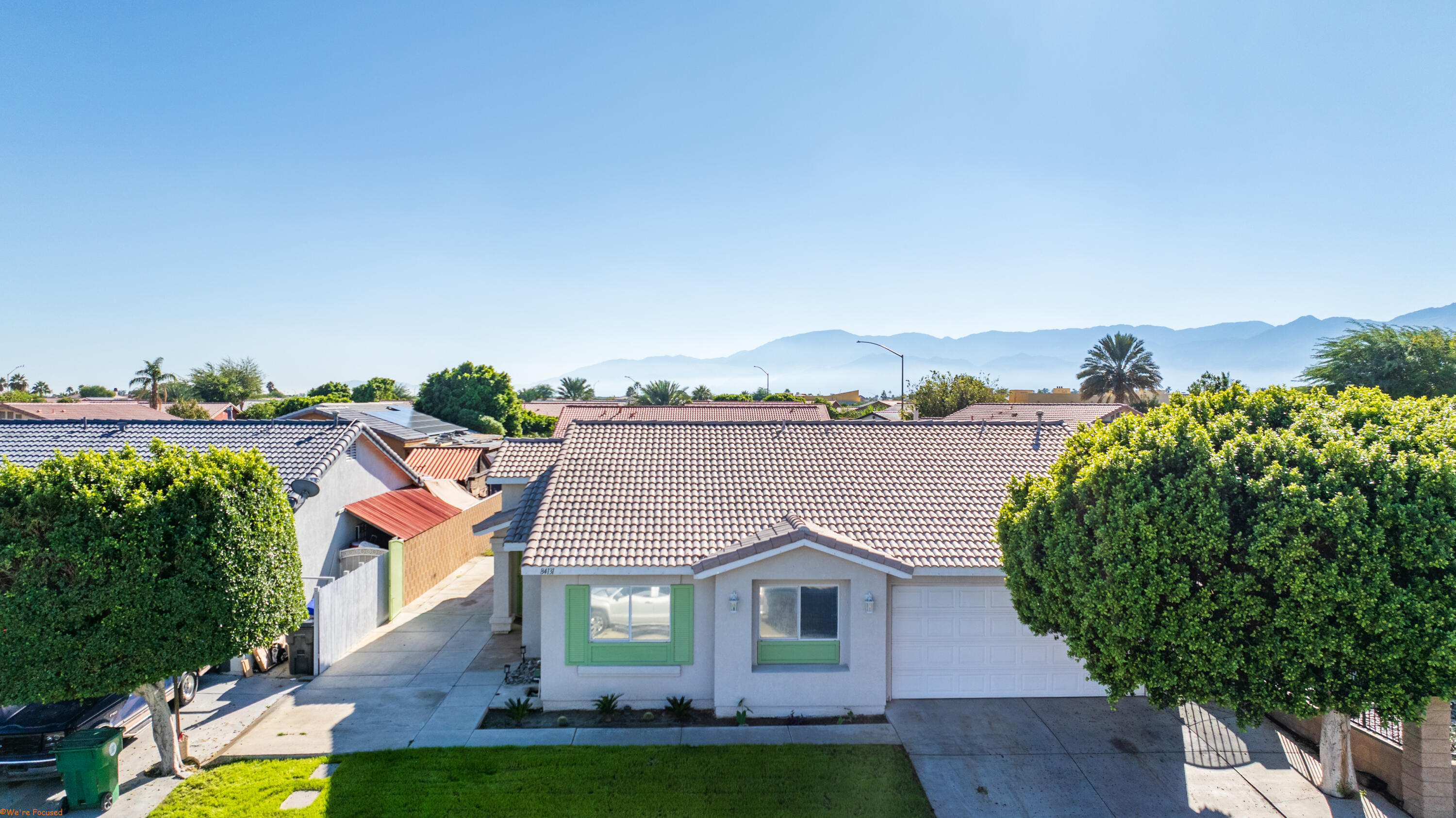 an aerial view of a house with a yard