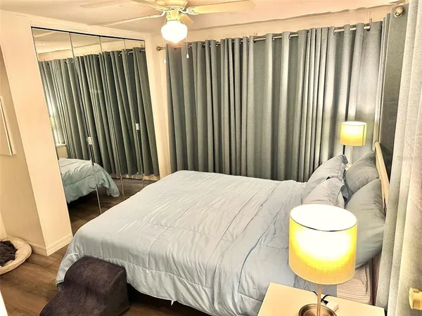 a bedroom with a bed and a mirror