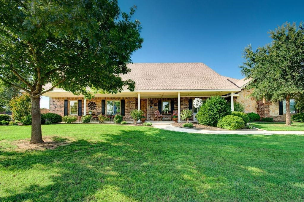 6506 15th Drive Lubbock, TX 79416 - Photo 1 of 42 a front view of a house with a garden