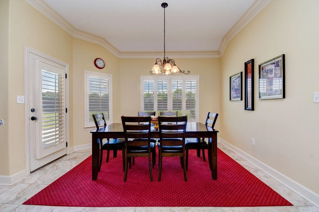 6506 15th Drive Lubbock, TX 79416 - Photo 17 of 42 a view of a dining room with furniture window and wooden floor