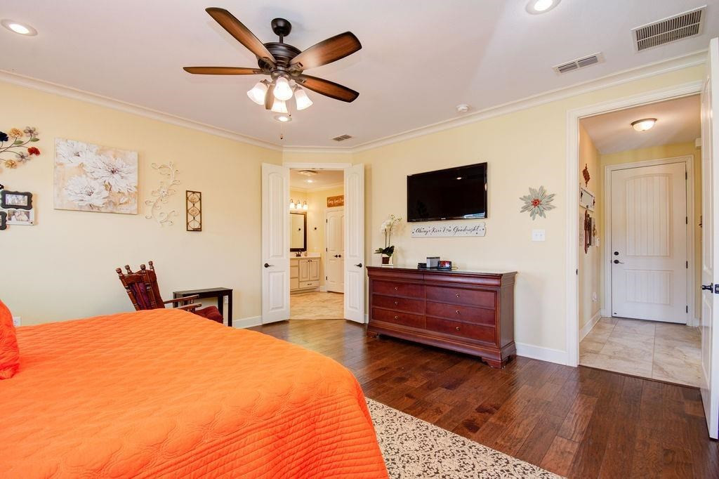 6506 15th Drive Lubbock, TX 79416 - Photo 19 of 42 a bed room with a bed and a television