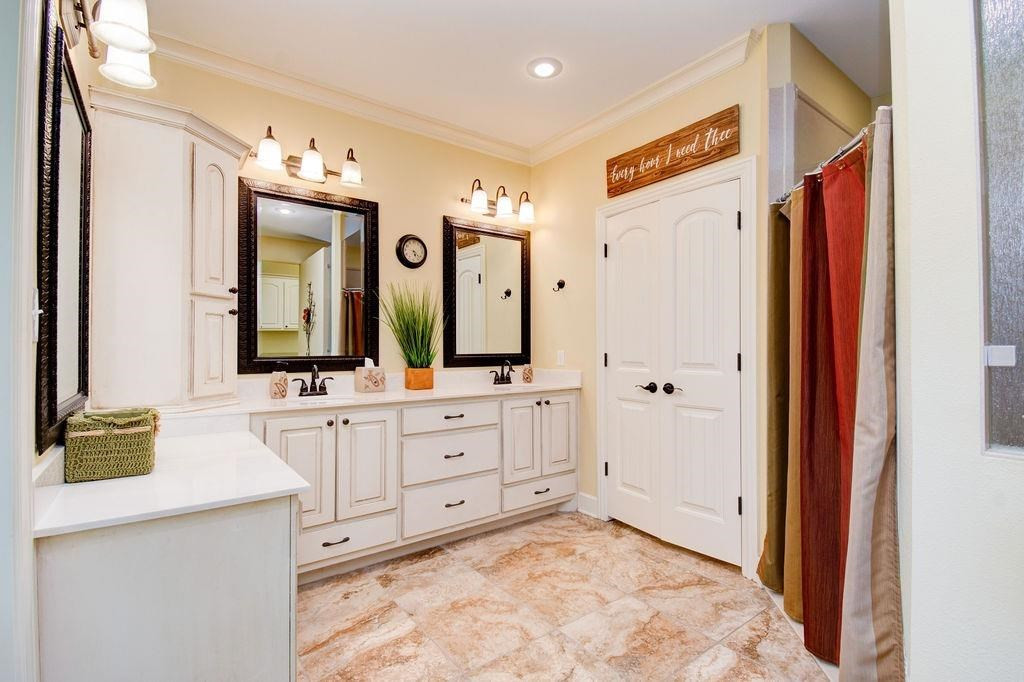 6506 15th Drive Lubbock, TX 79416 - Photo 21 of 42 a spacious bathroom with a sink mirror and a shower