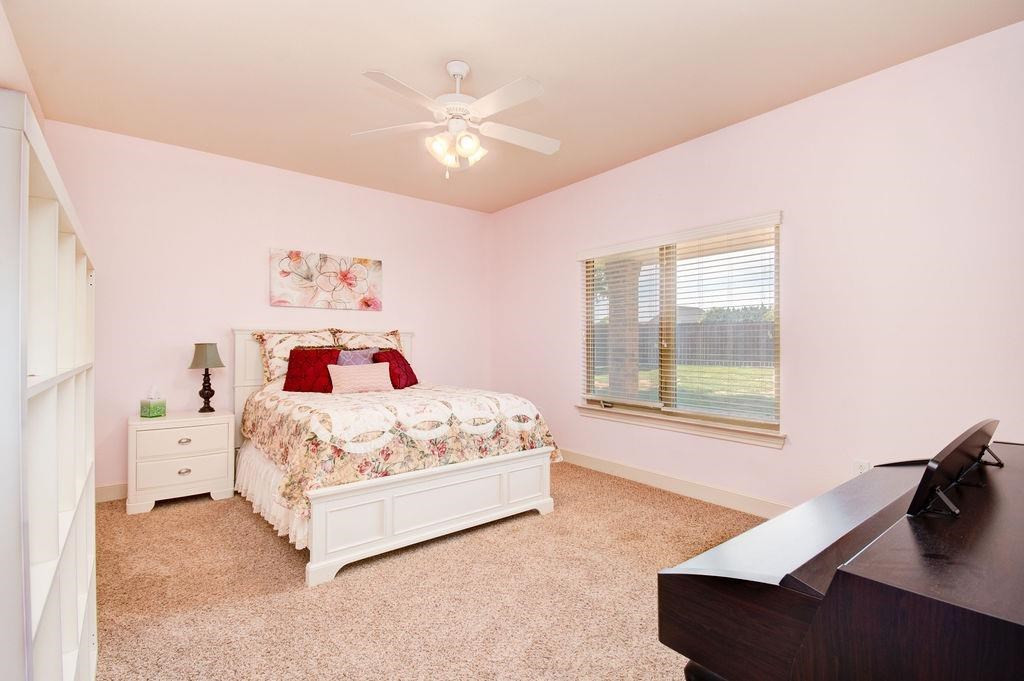 6506 15th Drive Lubbock, TX 79416 - Photo 30 of 42 a white bed sitting in a bedroom next to a window
