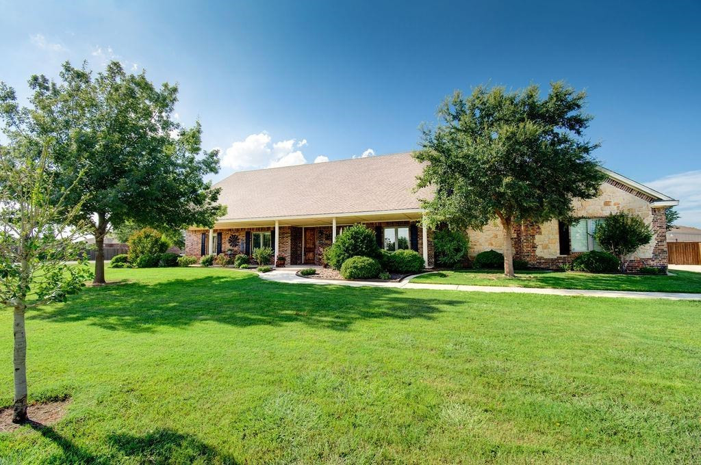 6506 15th Drive Lubbock, TX 79416 - Photo 3 of 42 a front view of a house with a garden