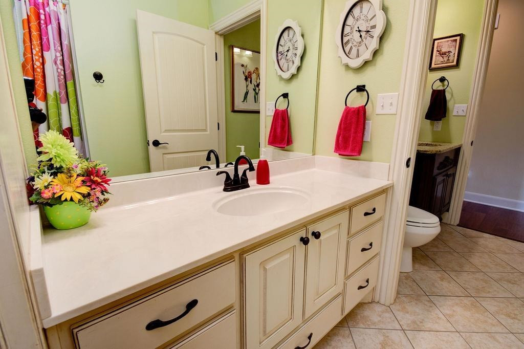 6506 15th Drive Lubbock, TX 79416 - Photo 33 of 42 a bathroom with a sink vanity and a mirror