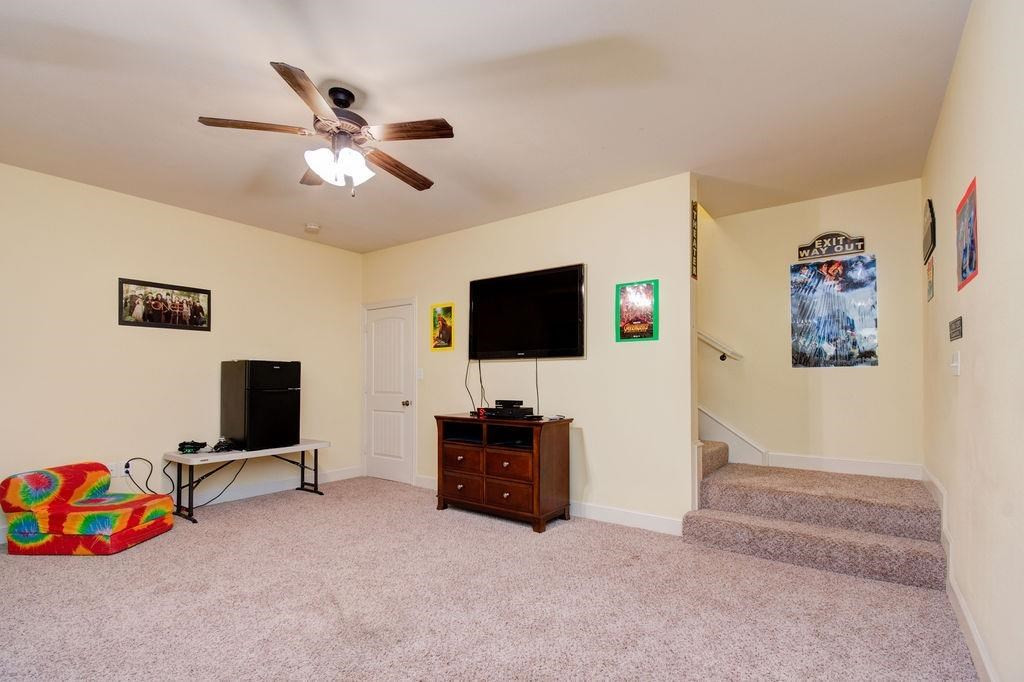 6506 15th Drive Lubbock, TX 79416 - Photo 36 of 42 a living room with furniture and a flat screen tv