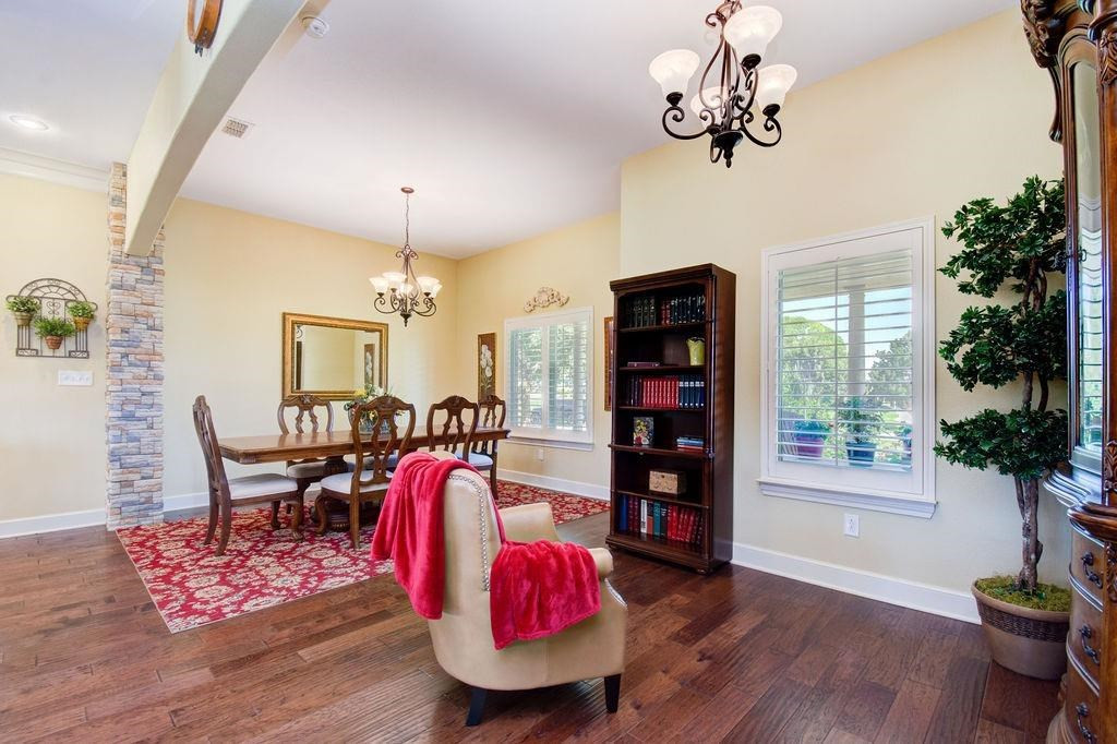 6506 15th Drive Lubbock, TX 79416 - Photo 5 of 42 a view of a dining room with furniture wooden floor and chandelier