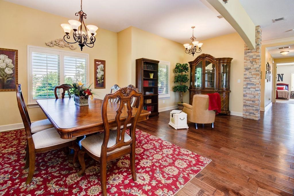 6506 15th Drive Lubbock, TX 79416 - Photo 7 of 42 a view of a dining room with furniture window and wooden floor