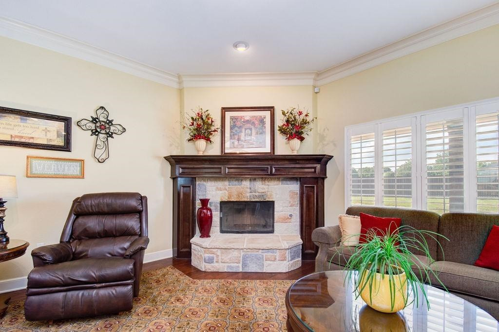 6506 15th Drive Lubbock, TX 79416 - Photo 10 of 42 a living room with furniture and a fireplace