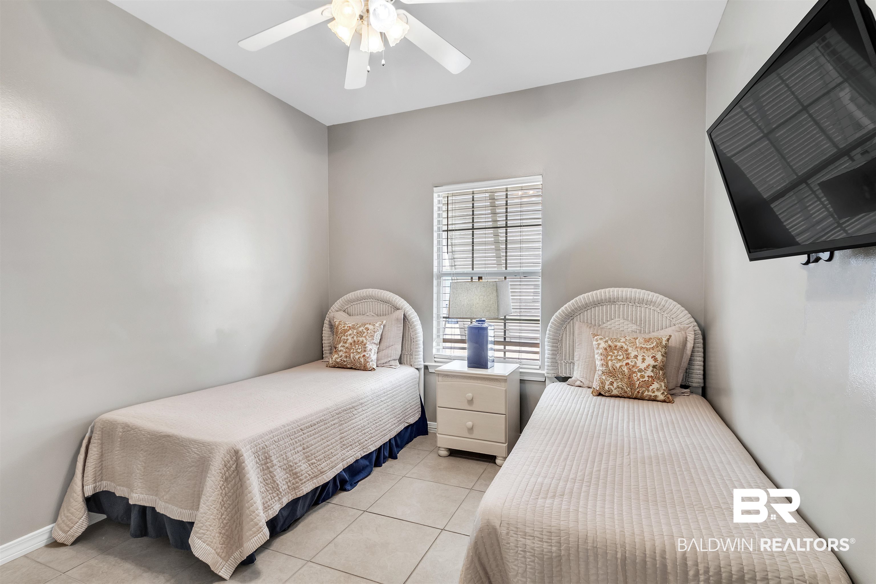 4324 B Lindsey Lane, Unit 4324B Orange Beach, AL 36561 - Photo 16 of 33 Bedroom with light tile patterned floors, a ceiling fan, and baseboards