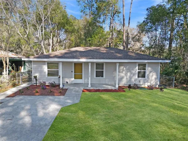 a front view of house with a garden and patio