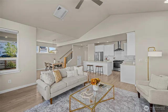 a living room with furniture and kitchen view