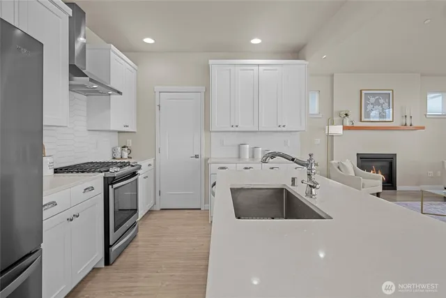 a kitchen with stainless steel appliances a refrigerator sink and cabinets
