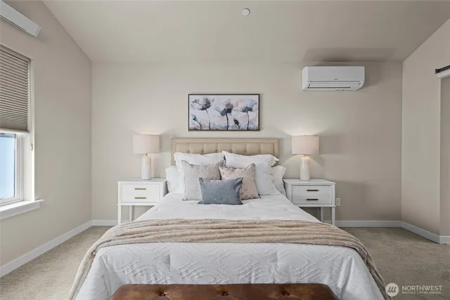 a bedroom with a bed and a painting on the wall