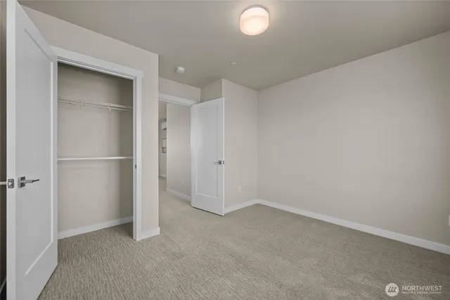 a bathroom with a granite countertop sink a toilet and a mirror