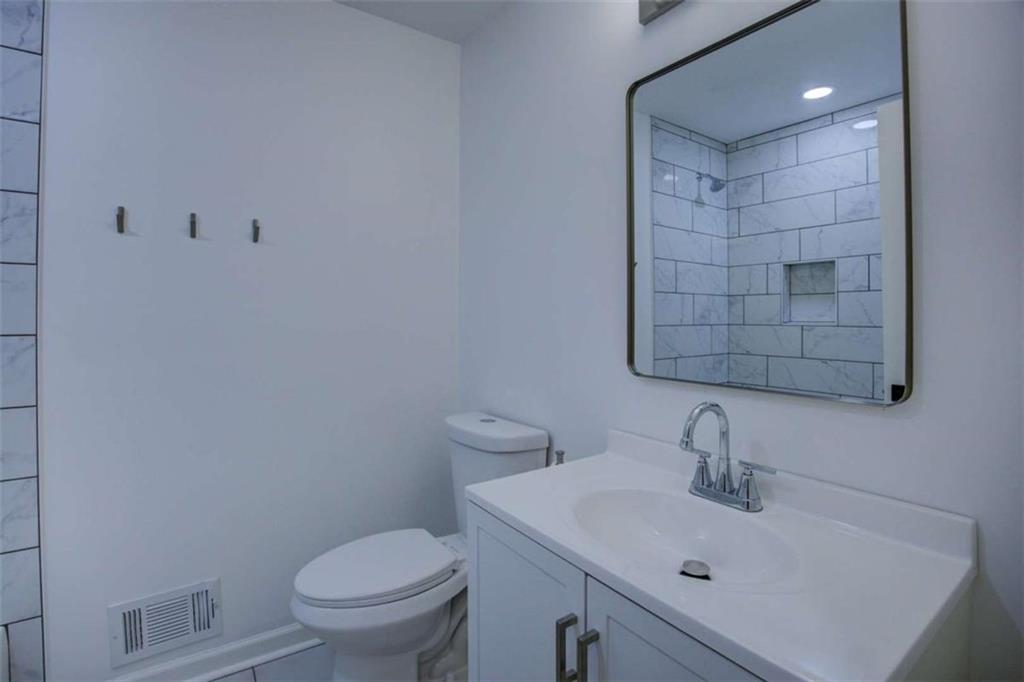 7225 Pineneedle Drive Southwest Covington, GA 30014 - Photo 27 of 37 a bathroom with a sink toilet and vanity