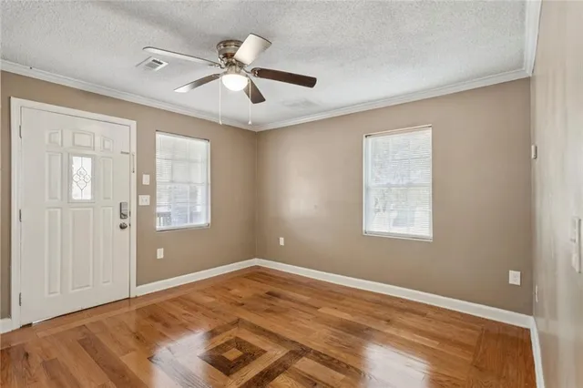 a view of a room with wooden floor and windows