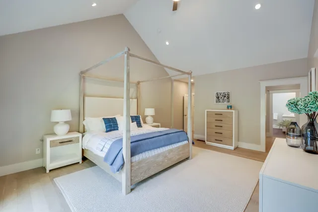 a spacious bedroom with a bed and a table