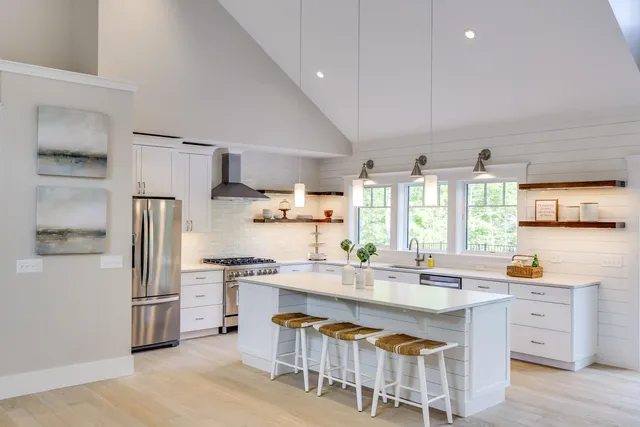 a kitchen with stainless steel appliances a sink stove and refrigerator