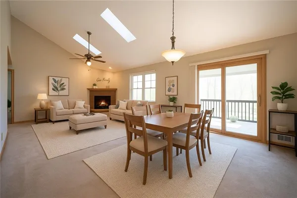 a living room with furniture a fireplace and a chandelier
