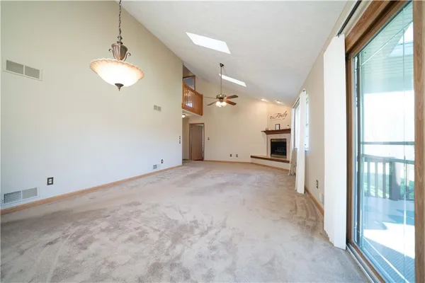a view of a room with a windows and ceiling fan