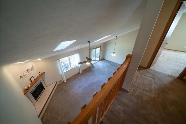 a view of a livingroom with an empty space and a fireplace