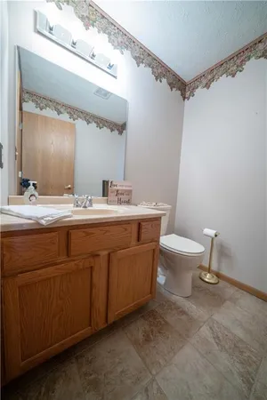 a bathroom with a double vanity sink toilet and a mirror